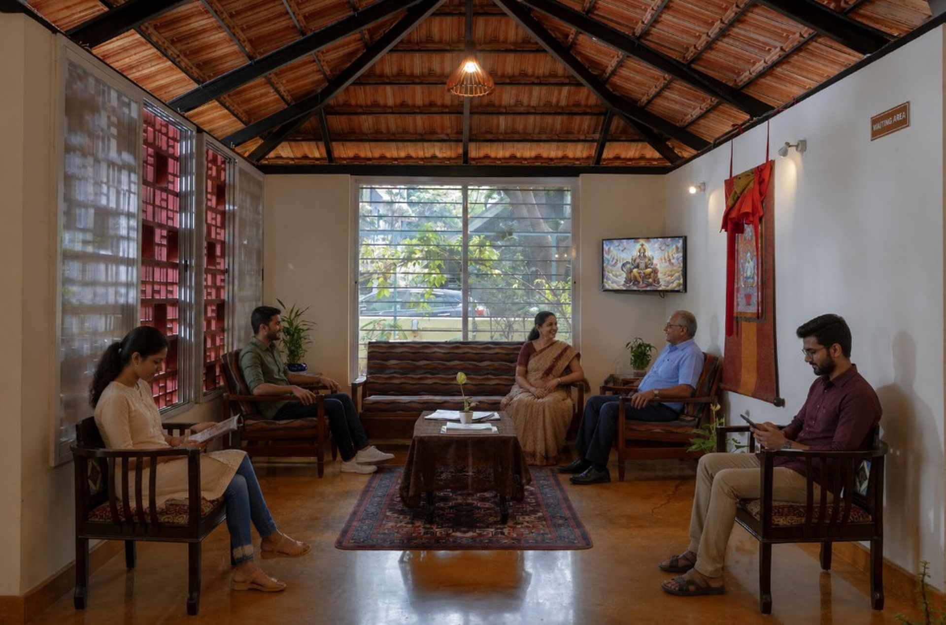 Saukhyabharathi waiting area with guests relaxing in a warm traditional lounge